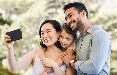 Image showing My loves, the light of my life. a happy young family taking selfies in a garden.