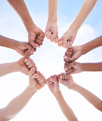 Image showing We can achieve it if we do it together. a group of unrecognizable people making a circle with their fists outside.