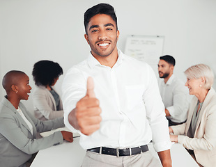 Image showing This meeting went well. a young businessman showing a thumbs up at work.