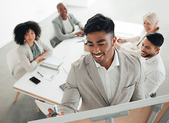 Image showing Fresh minds create great ideas. a young businessman writing on a whiteboard during a meeting at work.