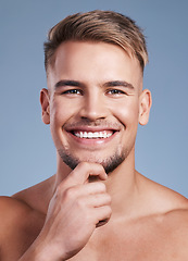 Image showing I have a little beard going on here. Closeup shot of a handsome young man smiling while posing against a studio background.