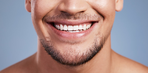 Image showing He has the most perfect smile. Closeup shot of a young man smiling while posing against a studio background.