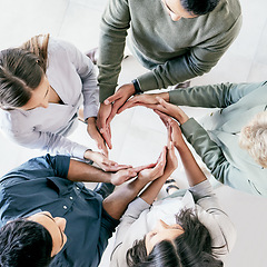 Image showing Do the hard jobs first. High angle shot of a group of unrecognizable businesspeople forming a circle with their hands at work.