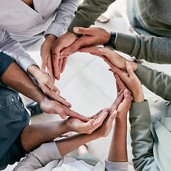 Image showing Success is the doing, not the getting. High angle shot of a group of unrecognizable businesspeople forming a circle with their hands at work.