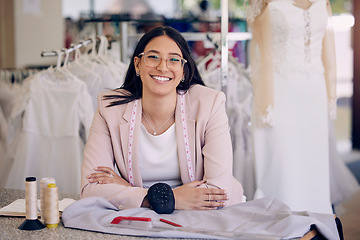 Image showing Her designs will leave you in awe. an attractive young seamstress working in a bridal boutique.