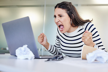 Image showing Its probably time to take a break. a young businesswoman looking angry while using a laptop in an office at work.