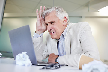 Image showing Will this be done today. a mature businessman looking overwhelmed while using a laptop in an office at work.