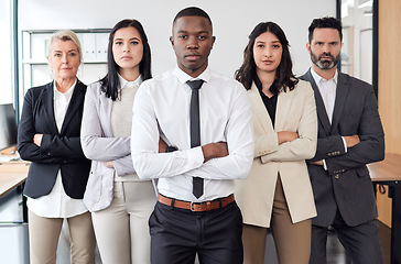 Image showing Theres nothing we cant do. a group of businesspeople standing in an office at work.