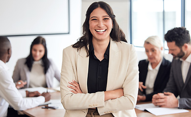 Image showing Our meetings always go well. a young businesswoman standing with her arms crossed during a meeting at work.