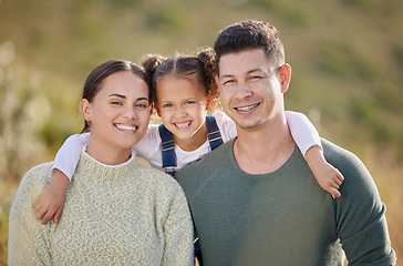 Image showing We have everything we need right here. a young couple spending time outdoors with their daughter.