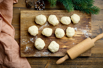 Image showing dough balls on wooden cutting board