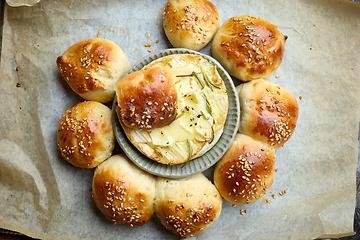 Image showing closeup of freshly baked bread buns with melted brie