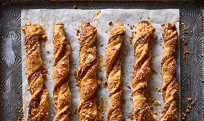 Image showing freshly baked pastries with chocolate cream and almonds