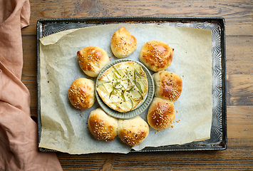 Image showing freshly baked buns and melted brie cheese