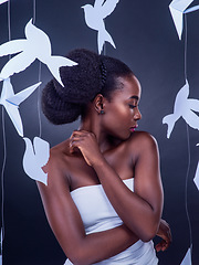 Image showing You wont know beauty into you discover freedom. Studio shot of a beautiful young woman posing with paper birds against a black background.