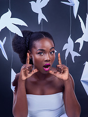 Image showing You dont need any reason to shine - shine for yourself. Studio portrait of a beautiful young woman posing with paper birds against a black background.