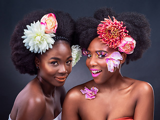 Image showing Let me introduce you to blossom and bloom. two beautiful women posing together with flowers in their hair.