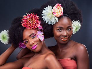 Image showing Theres no such thing as too much floral. two beautiful women posing together with flowers in their hair.