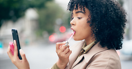 Image showing Outdoor, lipstick and woman with a smartphone, cosmetics and travel with mobile user, confidence and metro. Person, employee or girl in a city, cellphone and face beauty with aesthetic or consultant