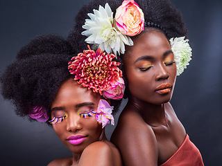 Image showing Dont just live, bloom. two beautiful women posing together with flowers in their hair.