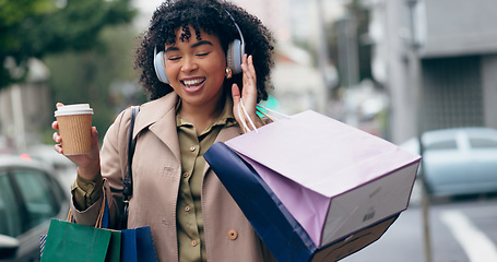 Image showing Headphones, shopping bag or happy woman in city for boutique retail sale, or clothes discount deal. Coffee, financial freedom or rich customer walking on street streaming radio music with fashion