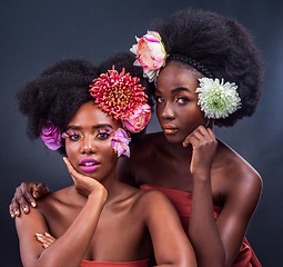 Image showing Flourishing in floral. two beautiful women posing together with flowers in their hair.