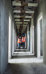 Image showing Wall to wall exceptional work. a young man and woman using a digital tablet while working at a construction site.