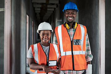 Image showing The harder we work the happier our clients are. a young man and woman using a digital tablet while working at a construction site.