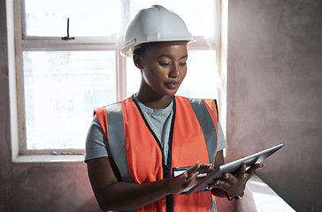 Image showing Safety inspection is first on the agenda. a young woman using a digital tablet while working at a construction site.