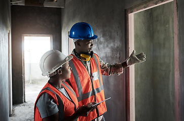 Image showing Their architectural brand is built on solid ground. a young man and woman having a discussion while working at a construction site.