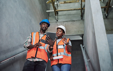 Image showing Quality work from concrete to completion. a young man and woman using a digital tablet while working at a construction site.