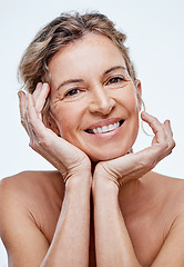 Image showing We can take steps to help our skin stay supple and fresh-looking. a beautiful mature woman posing against a white background.