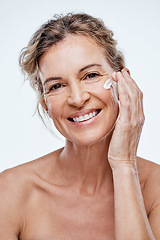 Image showing A good skincare routine is a must at any age. a mature woman posing with moisturiser on her face.