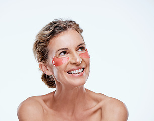 Image showing Youll see results fast. a mature woman wearing under-eye gel patches while posing against a white background.