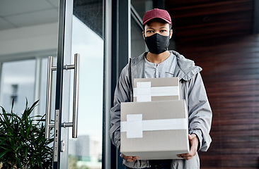 Image showing Wherever you are, well get it delivered. a masked young man delivering a package to a place of residence.