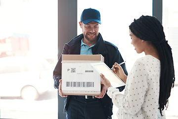 Image showing Great service that will leave every customer satisfied. a handsome delivery man getting a signature from a female customer for her order.