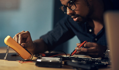 Image showing The technician to get your hardware sorted while you sleep. a young technician repairing computer hardware.