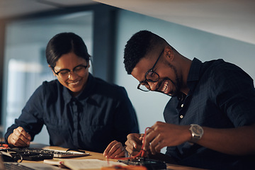 Image showing Have no fear, the tech experts are here. two young technicians repairing computer hardware together.