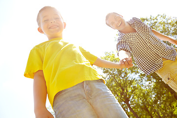 Image showing Special father-son moments. Young father and his son spending time outdoors while smiling widely.