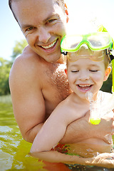 Image showing Enjoying our day by the lake. Happy father and son swimming in a lake.