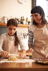 Image showing She loves baking. a little girl baking in the kitchen with her mother.