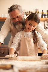 Image showing This is how we roll. a girl bonding with her grandfather as they bake in the kitchen.