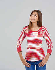 Image showing What to do today. Studio shot of an attractive young woman looking up on a grey background.