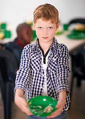 Image showing No child should be hungry. a young boy eating at a volunteer run kitchen.