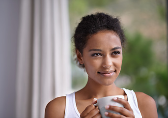 Image showing Nothing beats a relaxing warm morning drink. a young woman enjoying a cup of coffee.