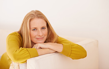 Image showing Enjoying some peace after a busy day. Portrait of a happy woman relaxing on a couch.