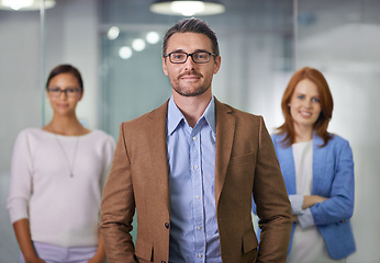 Image showing T.E.A.M. - Together Everyone Achieves More. Portrait of a businessman standing with his colleagues.