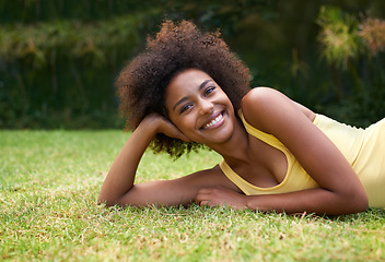 Image showing Having a happy day in the sun. Portrait of a happy young woman lying on the grass.
