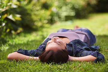 Image showing Do not disturb. an attractive young woman lying on the grass.