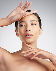 Image showing A beautiful young mixed race woman with glowing skin posing against grey copyspace background. Young confident woman doing a routine selfcare grooming routine with glowing radiant skin